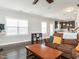 Open-concept living room with comfortable brown sofas, hardwood floors, and open concept kitchen at 105 Pink Dogwood Ln, Mebane, NC 27302