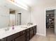 Spacious main bathroom with double sinks, large mirror, and walk-in closet at 105 Pink Dogwood Ln, Mebane, NC 27302