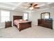 Main bedroom featuring a tray ceiling, fan, carpet, and ample natural light at 105 Pink Dogwood Ln, Mebane, NC 27302