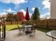 Outdoor patio with a table, umbrella, and chairs, ideal for enjoying the manicured backyard at 105 Pink Dogwood Ln, Mebane, NC 27302