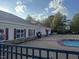 Community pool area showcasing the building exterior with stone accents and a red roof at 105 Pink Dogwood Ln, Mebane, NC 27302