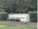 Community sign reading 'Ashbury' surrounded by lush landscaping at 105 Pink Dogwood Ln, Mebane, NC 27302