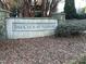 Stone community sign reading 'The Club at Ashbury' surrounded by landscaping at 105 Pink Dogwood Ln, Mebane, NC 27302