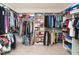 Organized walk-in closet boasts ample shelving, hanging space, and storage for clothes and accessories at 105 Pink Dogwood Ln, Mebane, NC 27302