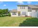 Backyard with a well-kept lawn and partial privacy fence with rear home elevation at 107 Meeting Hall Dr, Morrisville, NC 27560
