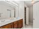 Bathroom with double sink vanity, storage closet, and a large mirror with overhead lighting at 107 Meeting Hall Dr, Morrisville, NC 27560