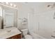 Bright bathroom featuring a white tub-shower combo, vanity, and large mirror with overhead lighting at 107 Meeting Hall Dr, Morrisville, NC 27560