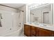 Bathroom with double sink vanity, white tile, and a shower-tub combination with neutral walls at 107 Meeting Hall Dr, Morrisville, NC 27560