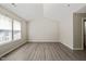 Bedroom with tall ceilings, wide window, and neutral walls with wood-look flooring at 107 Meeting Hall Dr, Morrisville, NC 27560