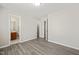 Bedroom showcasing wood-look flooring and access to a private bathroom with linen closet at 107 Meeting Hall Dr, Morrisville, NC 27560