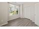 Cozy bedroom featuring a large window, neutral walls, closet, and light-colored hardwood flooring at 107 Meeting Hall Dr, Morrisville, NC 27560