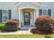 Inviting covered front porch with decorative columns and lush landscaping, creating a warm welcome at 107 Meeting Hall Dr, Morrisville, NC 27560