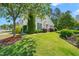 Charming home with well-maintained landscaping, a lush lawn, and mature trees providing shade at 107 Meeting Hall Dr, Morrisville, NC 27560
