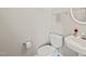 Clean half-bathroom with a sleek sink, toilet, round mirror, and neutral color scheme, ideal for guests at 107 Meeting Hall Dr, Morrisville, NC 27560