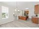 Open kitchen features an island, wood cabinets, stainless appliances, and flows into the living and dining area at 107 Meeting Hall Dr, Morrisville, NC 27560