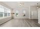Expansive living room featuring hardwood floors, neutral walls, multiple windows, and a cozy atmosphere at 107 Meeting Hall Dr, Morrisville, NC 27560