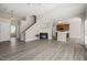 Open-concept living room with hardwood floors, a fireplace, and seamless transition to the kitchen at 107 Meeting Hall Dr, Morrisville, NC 27560