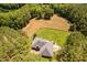 Aerial view of property featuring a home, large lot, treed landscape, and a horse pasture at 108 Cedarwood Dr, Louisburg, NC 27549