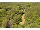 Beautiful aerial view showcases the property's vast land, woods, and tranquil setting at 108 Cedarwood Dr, Louisburg, NC 27549