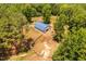 Scenic aerial view of horse barn and surrounding land, showcasing wooded acreage and serene setting at 108 Cedarwood Dr, Louisburg, NC 27549