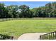 Expansive backyard featuring a wood fence and mature trees, perfect for outdoor activities and enjoying nature at 108 Cedarwood Dr, Louisburg, NC 27549