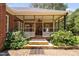 Backyard view of the stone patio and covered porch at 108 Cedarwood Dr, Louisburg, NC 27549