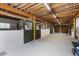 View of horse stalls inside the barn, featuring an open rafter ceiling and concrete floor at 108 Cedarwood Dr, Louisburg, NC 27549