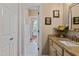 Bathroom featuring a neutral sink vanity, decor, and hallway access at 108 Cedarwood Dr, Louisburg, NC 27549