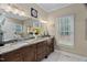 Elegant bathroom featuring a double sink vanity, marble countertops, and a large mirror at 108 Cedarwood Dr, Louisburg, NC 27549
