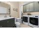 Bathroom and laundry room combo with gray cabinets and matching gray vanity at 108 Cedarwood Dr, Louisburg, NC 27549