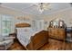 Cozy bedroom with hardwood floors, complemented by a stylish bed, dresser, and a chair for reading at 108 Cedarwood Dr, Louisburg, NC 27549