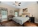 Cozy bedroom with a wicker headboard, ceiling fan, and plenty of natural light at 108 Cedarwood Dr, Louisburg, NC 27549