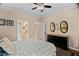 Comfortable bedroom featuring a ceiling fan, neutral walls, and ensuite bathroom access at 108 Cedarwood Dr, Louisburg, NC 27549
