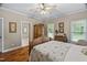 Comfortable bedroom featuring hardwood floors, neutral walls, and ample natural light at 108 Cedarwood Dr, Louisburg, NC 27549