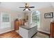 Brightly-lit craft room with hardwood floors, large windows, and built-in cabinetry at 108 Cedarwood Dr, Louisburg, NC 27549