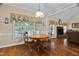 Charming dining area with backyard view and classic chandelier lighting at 108 Cedarwood Dr, Louisburg, NC 27549