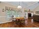 Dining room with hardwood floors and a view of the back yard and fireplace at 108 Cedarwood Dr, Louisburg, NC 27549