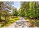 Gravel driveway winding through a tree lined path to residence at 108 Cedarwood Dr, Louisburg, NC 27549