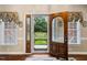 Inviting entryway with a decorative wood door and large windows overlooking the front yard at 108 Cedarwood Dr, Louisburg, NC 27549