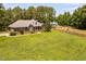 Expansive brick home with lush green lawn and equestrian facilities in a serene setting at 108 Cedarwood Dr, Louisburg, NC 27549
