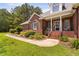 Inviting front porch with elegant columns and lush landscaping creating a warm entry at 108 Cedarwood Dr, Louisburg, NC 27549