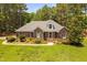 Beautifully landscaped brick home with a manicured lawn creating an inviting outdoor space at 108 Cedarwood Dr, Louisburg, NC 27549
