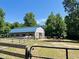 Horse barn with horses and fence line, offering an equestrian lifestyle and outdoor enjoyment at 108 Cedarwood Dr, Louisburg, NC 27549
