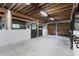 Spacious horse stall featuring white walls, wood ceiling, and dark sliding door for a modern, functional equine space at 108 Cedarwood Dr, Louisburg, NC 27549