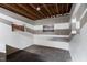 Stall interior featuring bright white walls with sturdy wood beams, small grated windows, and concrete flooring at 108 Cedarwood Dr, Louisburg, NC 27549