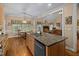 Open kitchen featuring granite counters, stainless steel appliances, and wood floors at 108 Cedarwood Dr, Louisburg, NC 27549