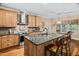 Modern kitchen with granite countertops, stainless steel appliances, and a center island with bar seating at 108 Cedarwood Dr, Louisburg, NC 27549