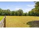 Expansive fenced land surrounded by mature trees offers privacy and potential at 108 Cedarwood Dr, Louisburg, NC 27549