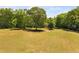 Spacious pasture surrounded by mature trees, perfect for equestrian or agricultural pursuits at 108 Cedarwood Dr, Louisburg, NC 27549