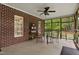 Comfortable screened-in patio with a ceiling fan and view of the landscaped backyard, creating a serene outdoor living space at 108 Cedarwood Dr, Louisburg, NC 27549